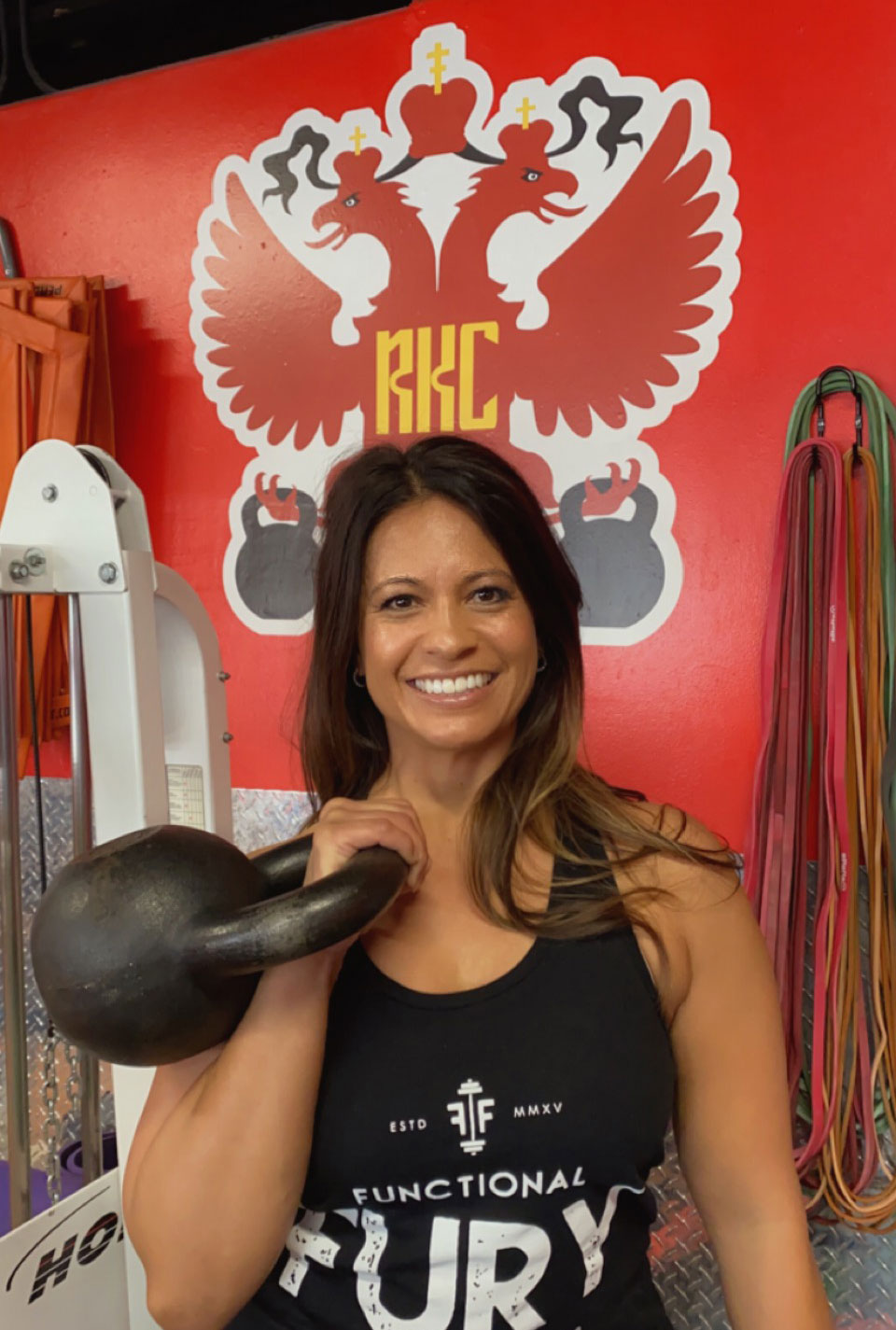 Jessica Pino RKC standing with kettlebell at Functional Fury Gym in New Mexico