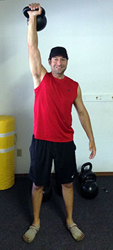 Jordan Rubin Pressing a kettlebell overhead