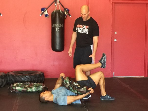 Josh Henkin Coaching the Ultimate Sandbag Glute Bridge