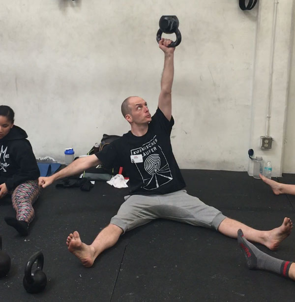 Nick Collias Straddle bottom up kettlebell press RKC