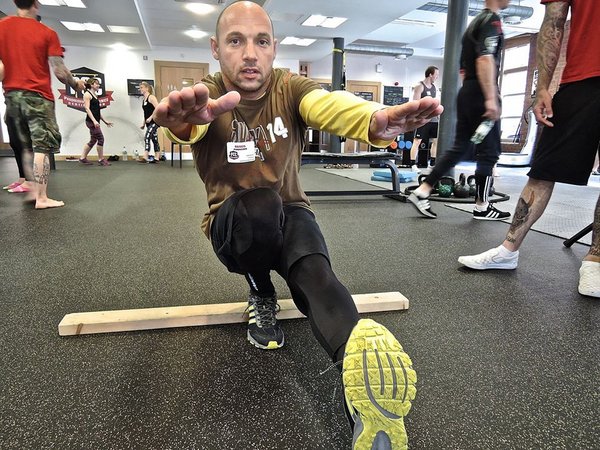 Renos Panagidis tries out a pistol squat regression at the UK PCC workshop