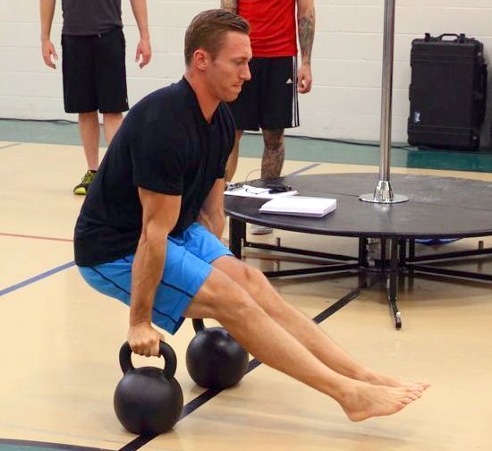 Tanner Martty Performs an L-Sit on kettlebells at the PCC workshop