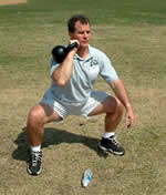 College Strength and Conditioning Coach Ethan Reeve practices Kettlebell squats